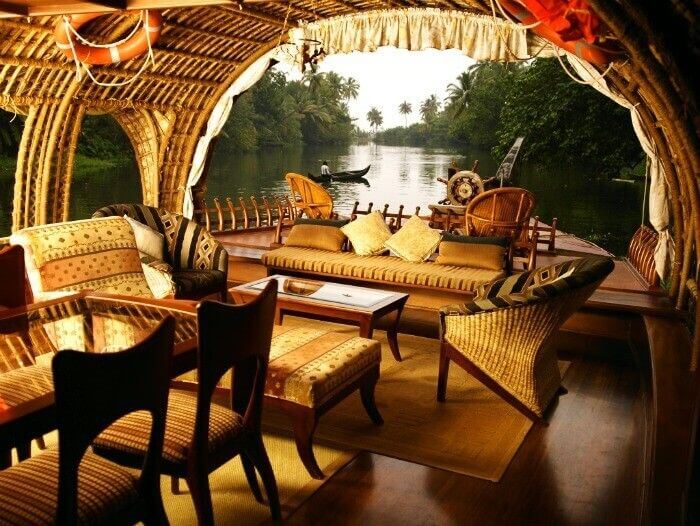 The lush green landscape and being served a freshly prepared meal at Houseboat in Alleppey, Kerala
