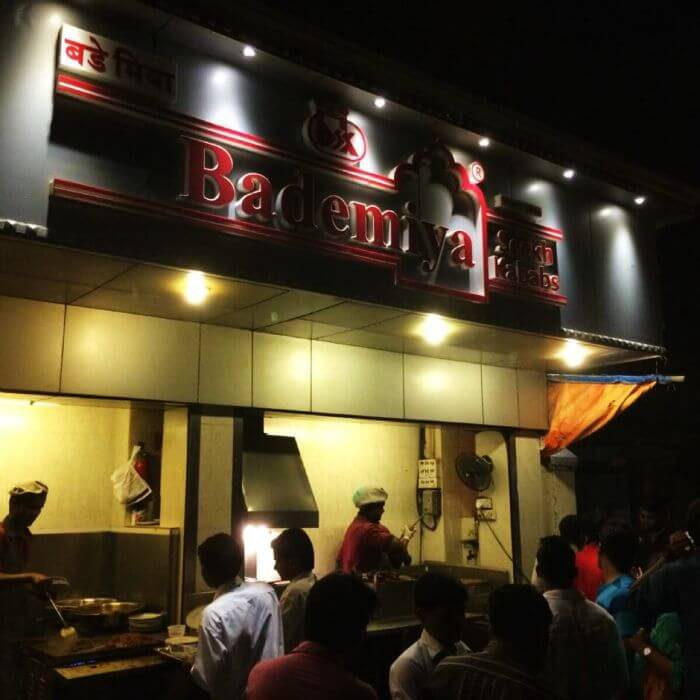 People trying some delicious food at Bademiya in Mumbai at night