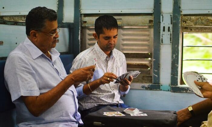 Passengers playing cards in Mumbai Local