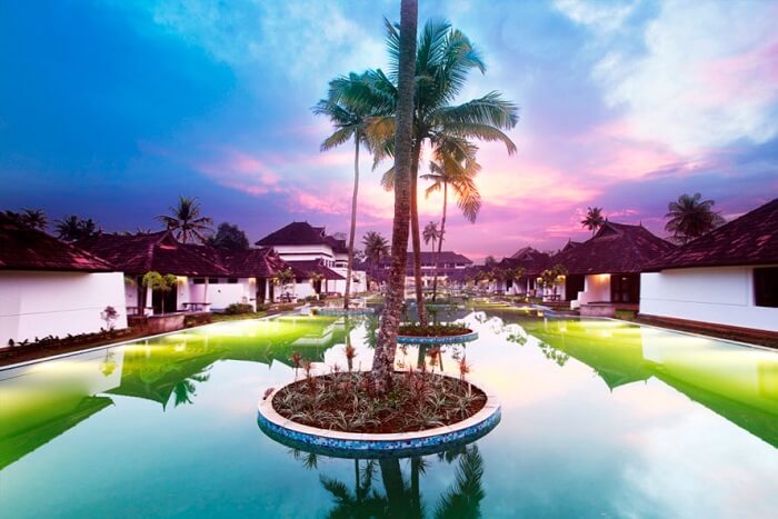 An evening shot of the grand pool at Aveda Resort in Kumarakom